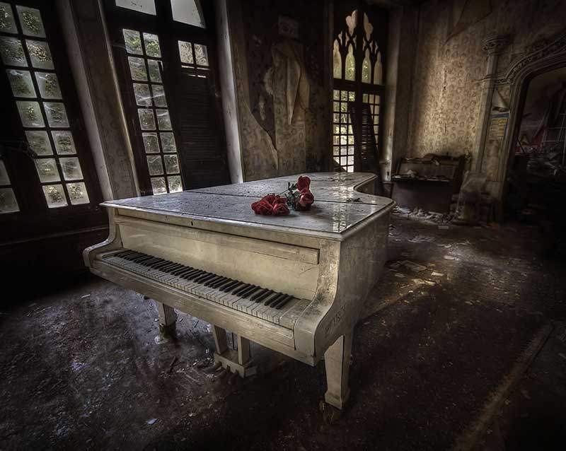 Great white piano in abandoned manor house